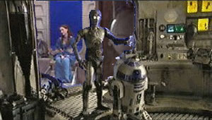 Padmé and Threepio and Artoo in the Lars' garage