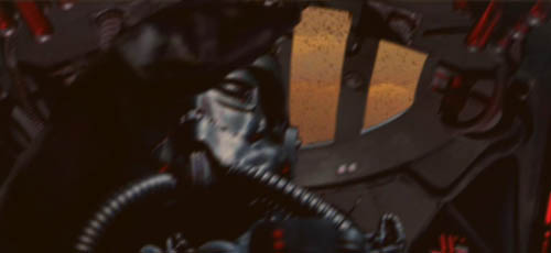 The TIE pilot throws his arms up in alarm !