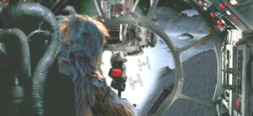 Chewie roars triumphantly as the pursuing TIEs and the reactor support brace explode.