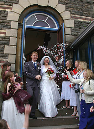 Joanne and Nathaniel under an arc of confetti