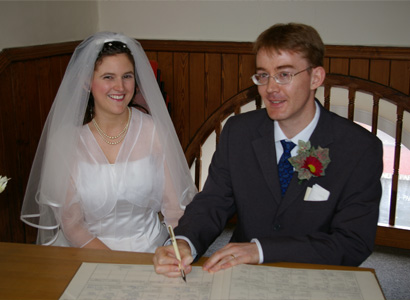 Joanne and Nathaniel sign the Register