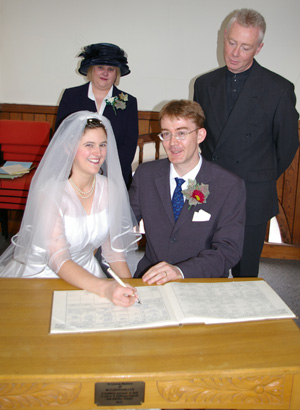 The Witnesses, Sue (Jo's sister) and Nigel (Nat's brother), oversee the signing